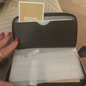Two Michael Kors wallets brand new never used for 80 dollars or each 40.